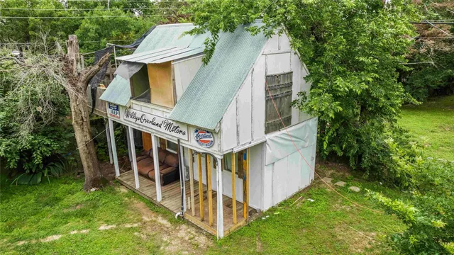 a view of a house with a yard and a garden
