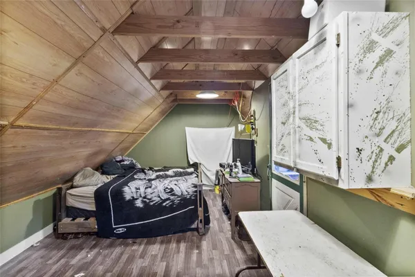 a view of a room with wooden floor and furniture