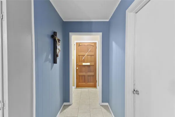 a view of a hallway with a wooden cabinet