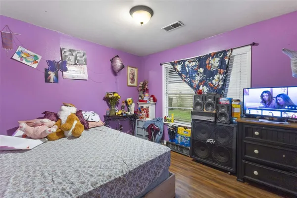 a bed room with a bed and a dresser