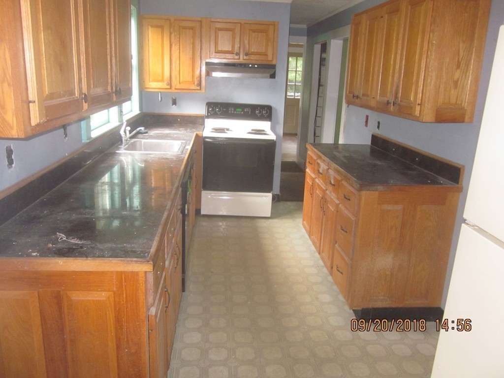 26 Waterhouse Road Bourne, MA 02532 - Photo 11 of 28 a kitchen with granite countertop a refrigerator and a sink