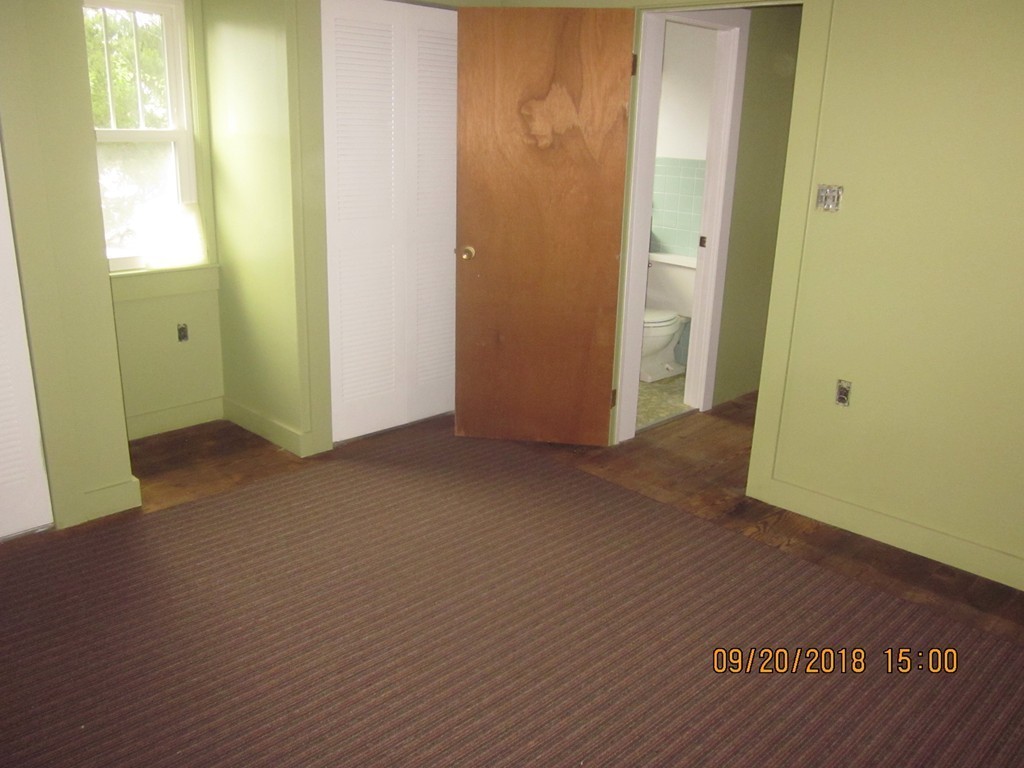26 Waterhouse Road Bourne, MA 02532 - Photo 22 of 28 an empty room with wooden floor and windows