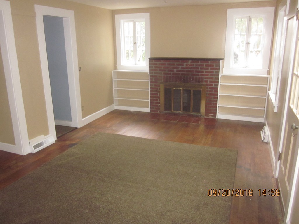 26 Waterhouse Road Bourne, MA 02532 - Photo 5 of 28 a view of empty room with window and fireplace