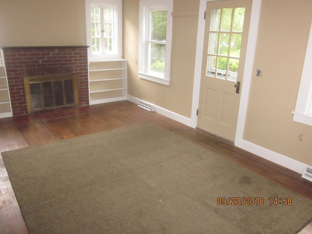 26 Waterhouse Road Bourne, MA 02532 - Photo 6 of 28 an empty room with windows and fireplace