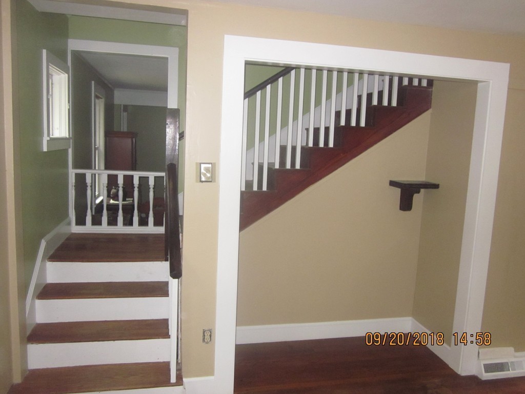 26 Waterhouse Road Bourne, MA 02532 - Photo 7 of 28 a view of staircase with lots of frames on wall and a window