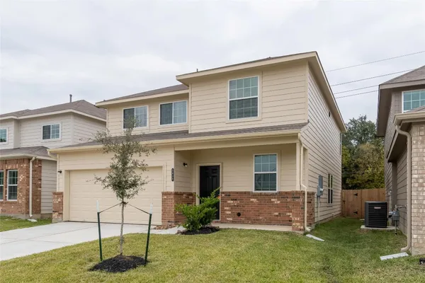 a view of a house with a yard and plants