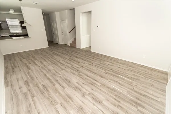 an empty room with wooden floor