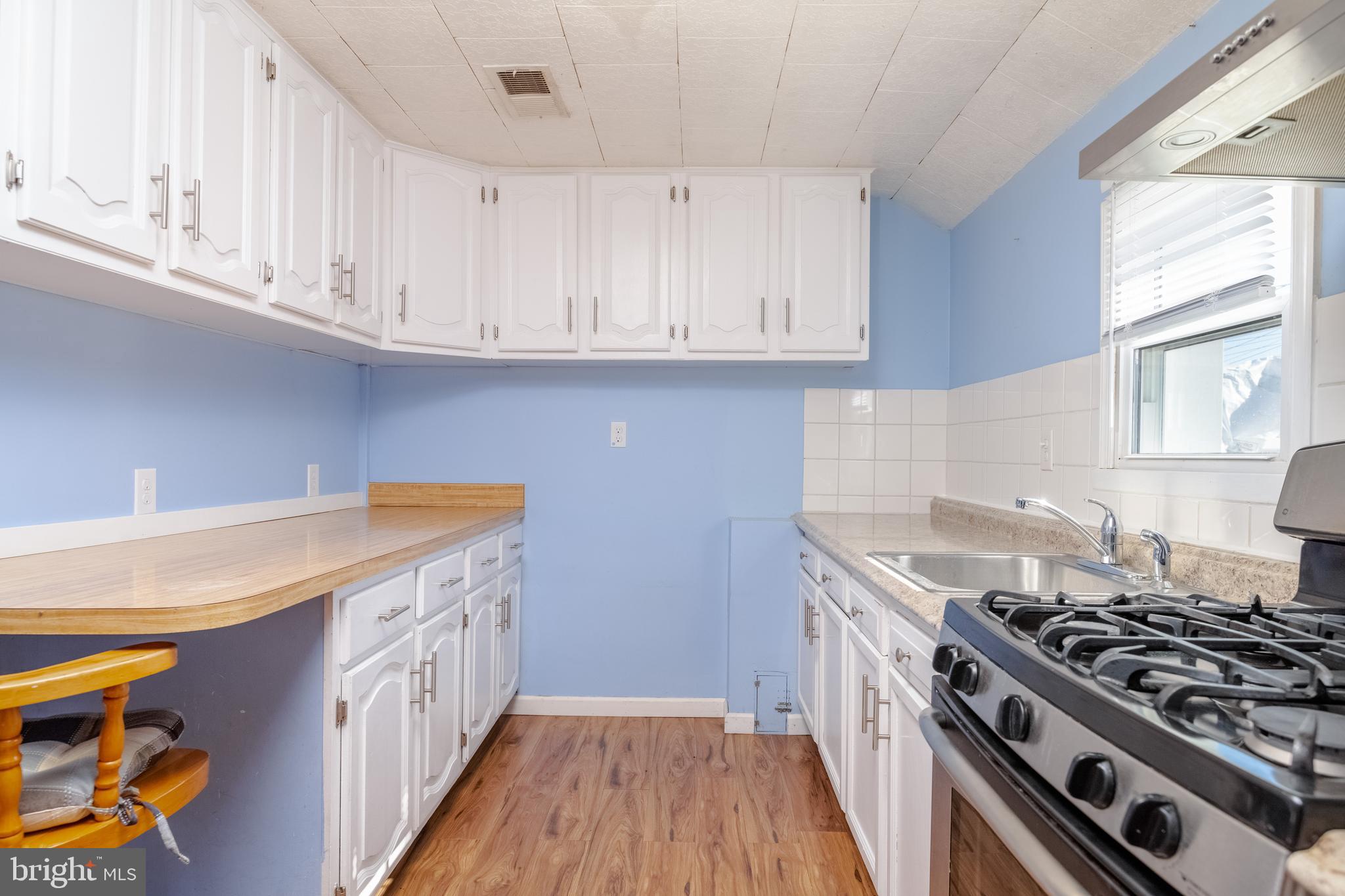 3171 Baybriar Road Dundalk, MD 21222 - Photo 22 of 41 a kitchen with stainless steel appliances granite countertop a stove and a white cabinets