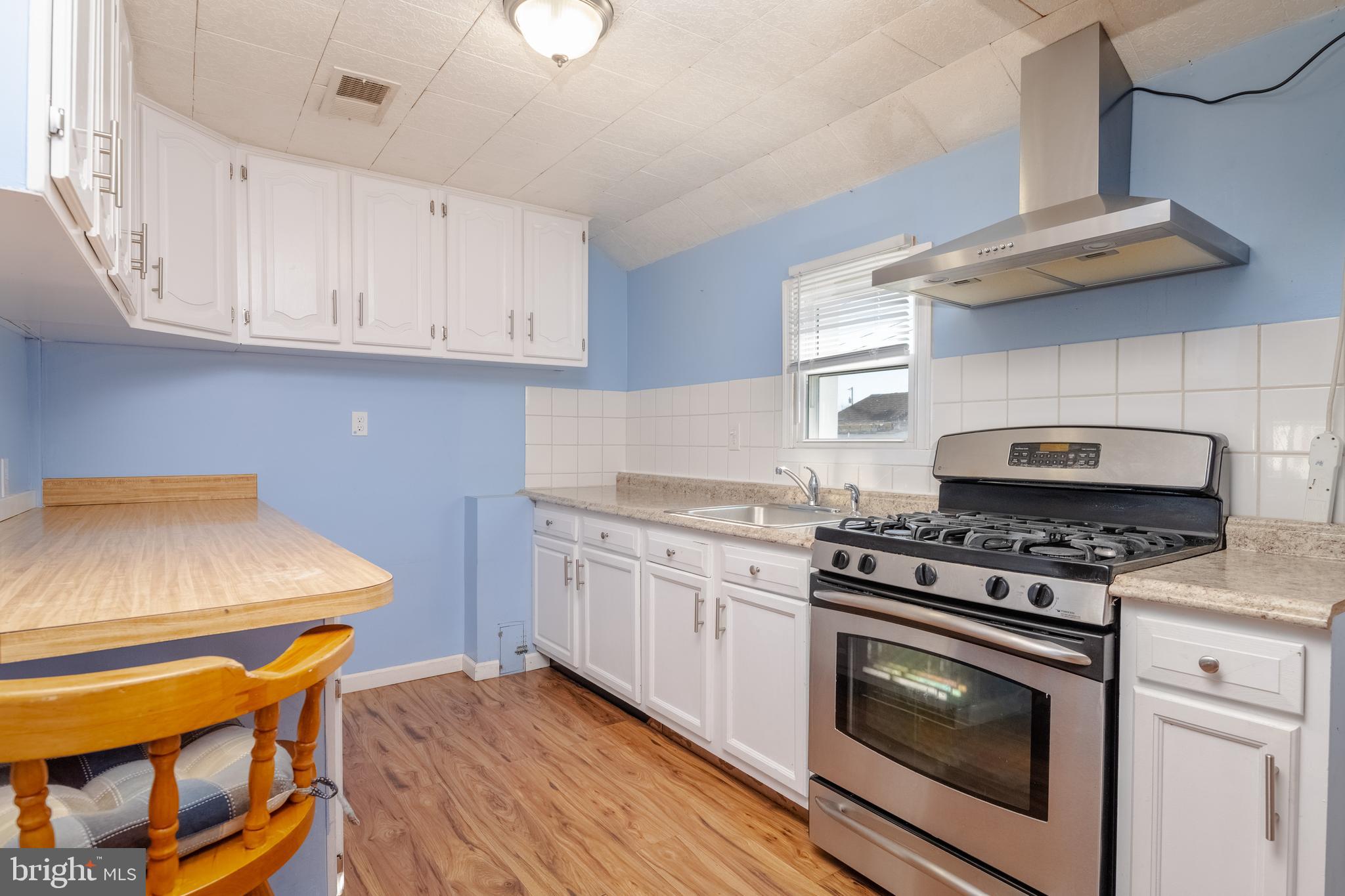 3171 Baybriar Road Dundalk, MD 21222 - Photo 23 of 41 a kitchen with stainless steel appliances granite countertop a stove and a cabinets
