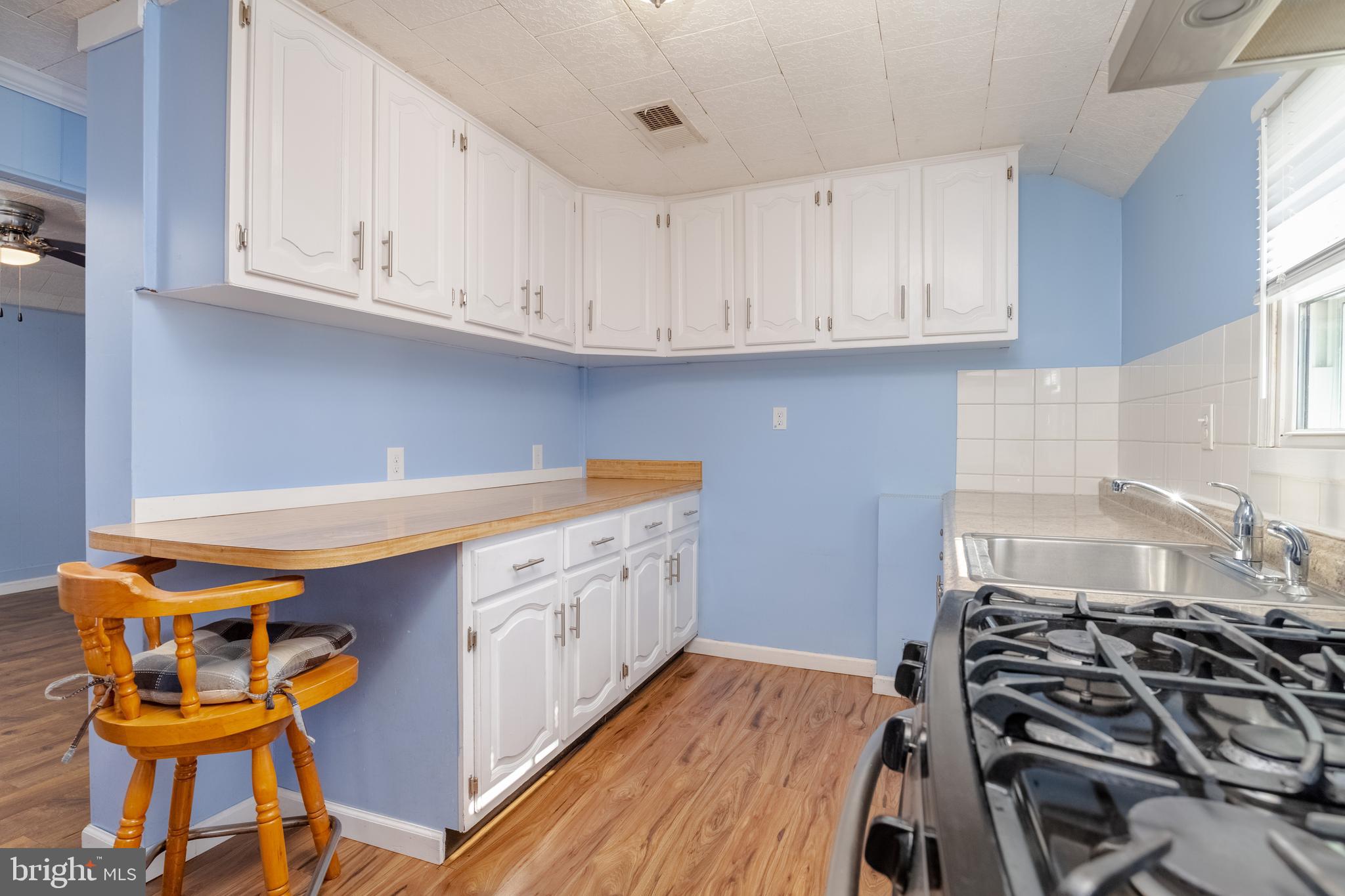 3171 Baybriar Road Dundalk, MD 21222 - Photo 24 of 41 a kitchen with stainless steel appliances granite countertop a stove and white cabinets