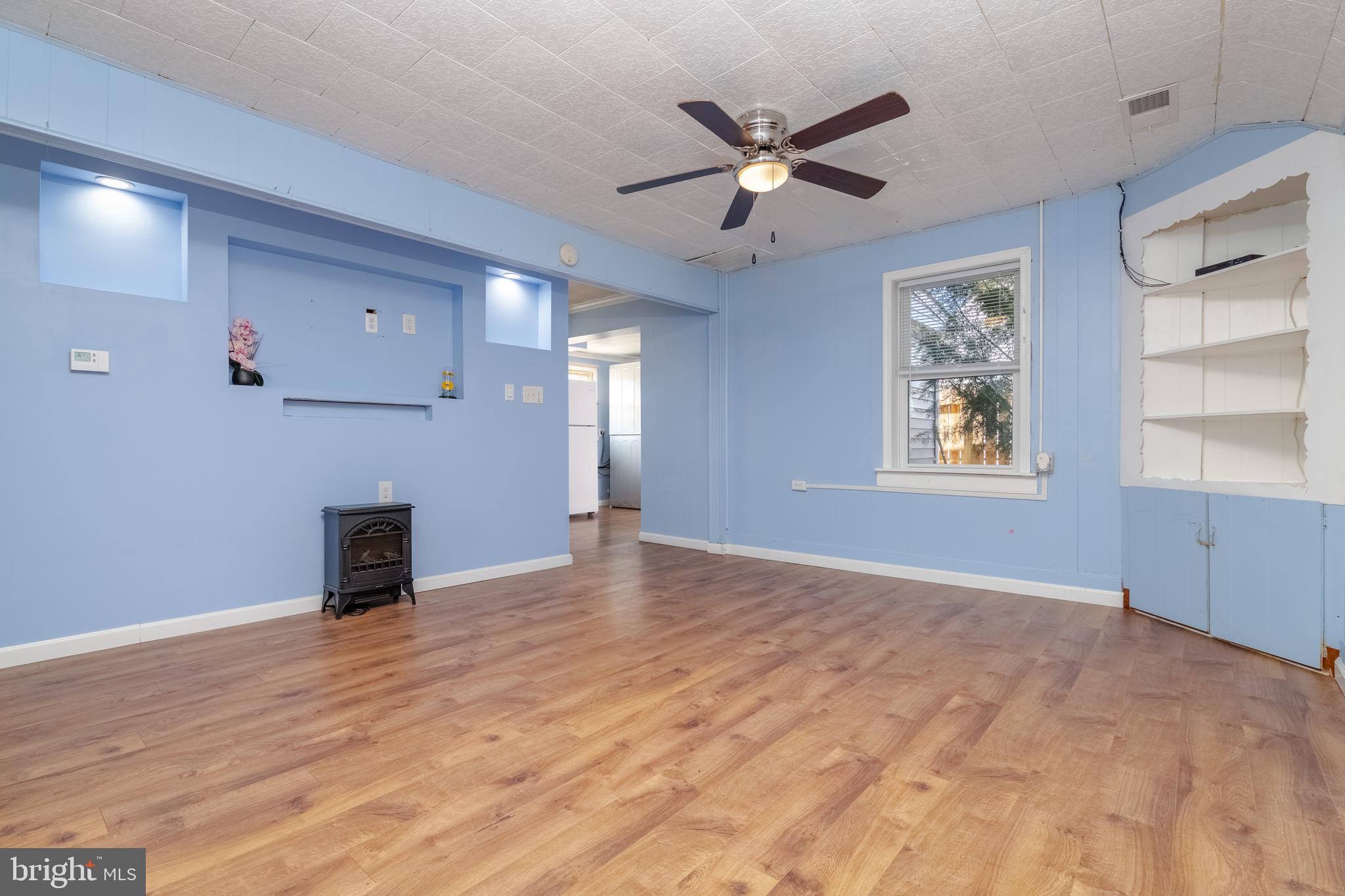 3171 Baybriar Road Dundalk, MD 21222 - Photo 9 of 41 a view of an empty room with a window and wooden floor