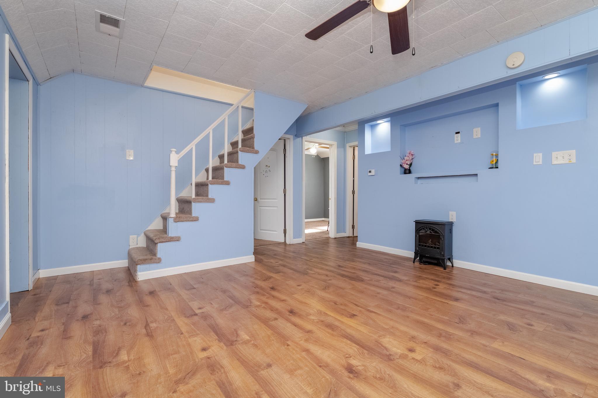 3171 Baybriar Road Dundalk, MD 21222 - Photo 10 of 41 a view of a livingroom with an empty space and a ceiling fan