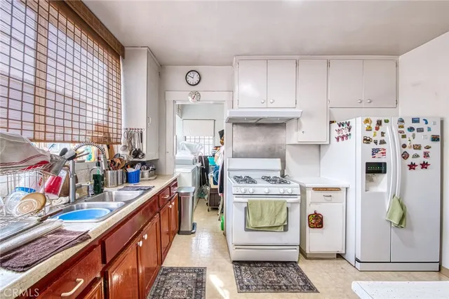a kitchen with refrigerator and stove
