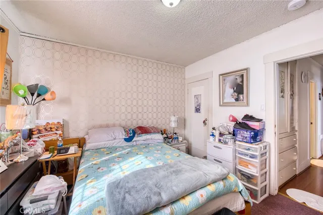 a bedroom with a bed and a potted plant