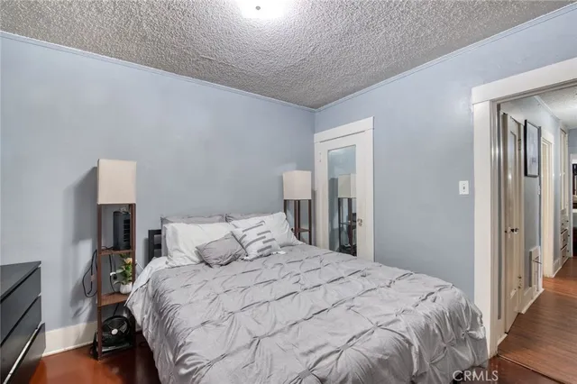 a bedroom with a bed and a night stand