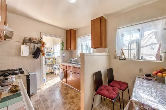 a kitchen with stainless steel appliances granite countertop a refrigerator and a stove top oven