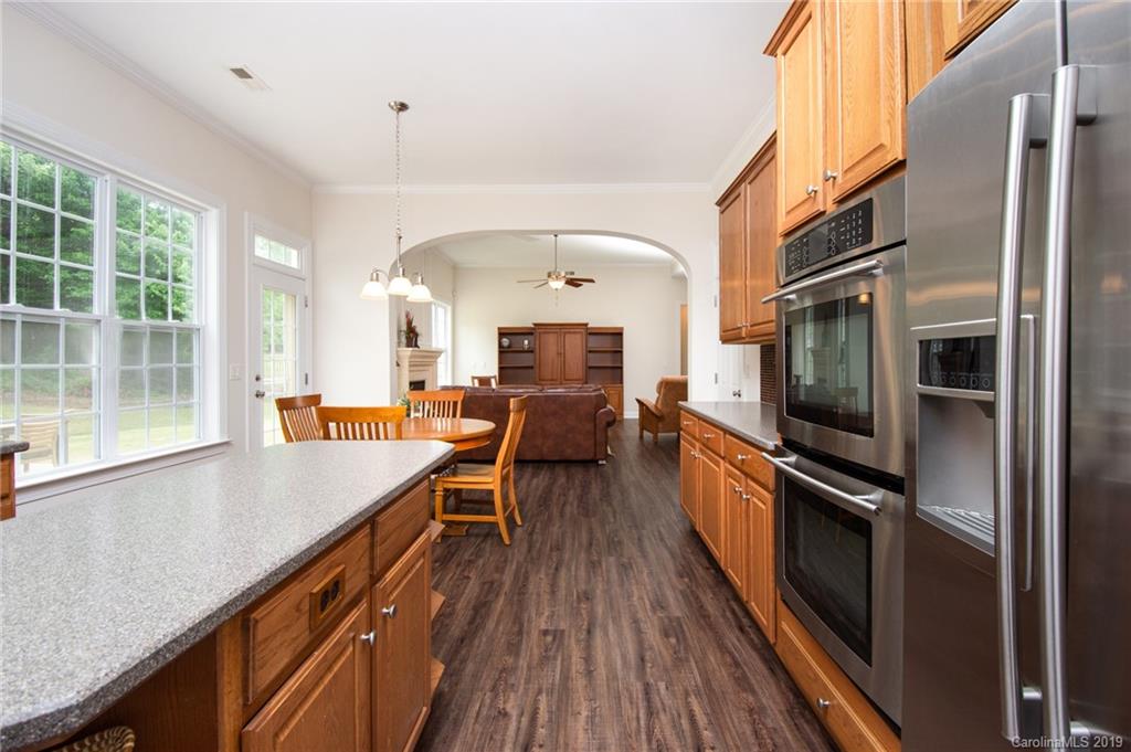 538 Quicksilver Trail Fort Mill, SC 29708 - Photo 12 of 39 a view of a kitchen with a sink and wooden floor
