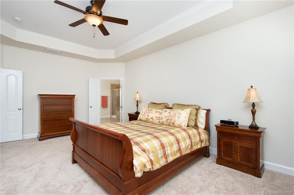 538 Quicksilver Trail Fort Mill, SC 29708 - Photo 19 of 39 a bedroom with a bed and a chandelier