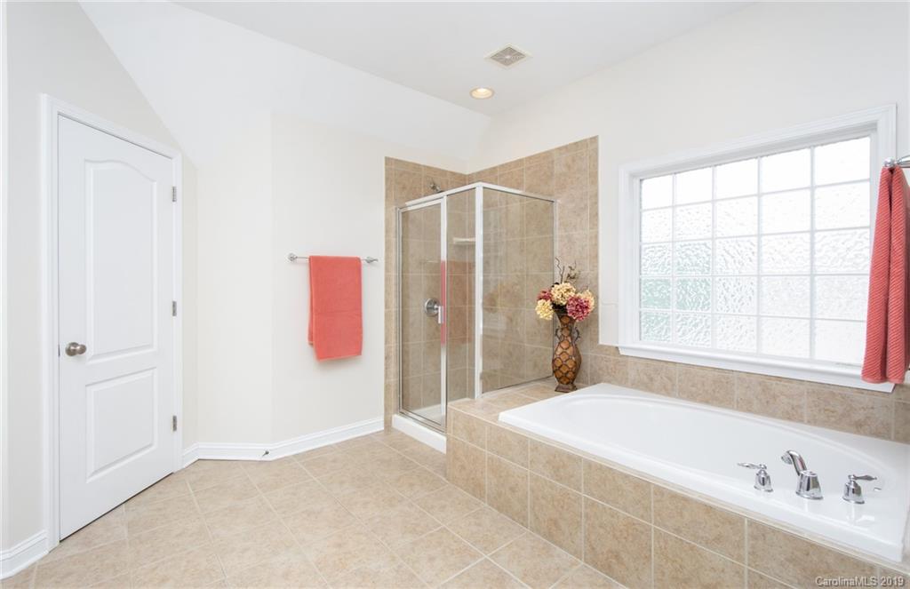 538 Quicksilver Trail Fort Mill, SC 29708 - Photo 20 of 39 a spacious bathroom with a tub shower and a window