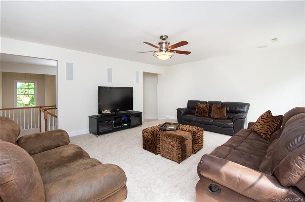 538 Quicksilver Trail Fort Mill, SC 29708 - Photo 24 of 39 a living room with furniture a flat screen tv and a window