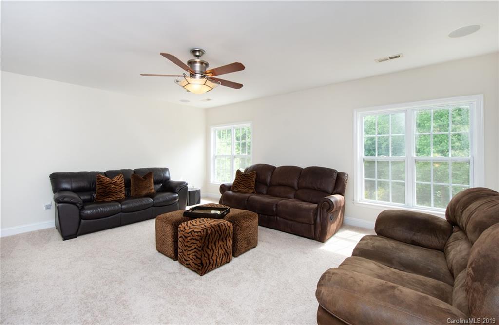 538 Quicksilver Trail Fort Mill, SC 29708 - Photo 25 of 39 a living room with furniture ceiling fan and a window