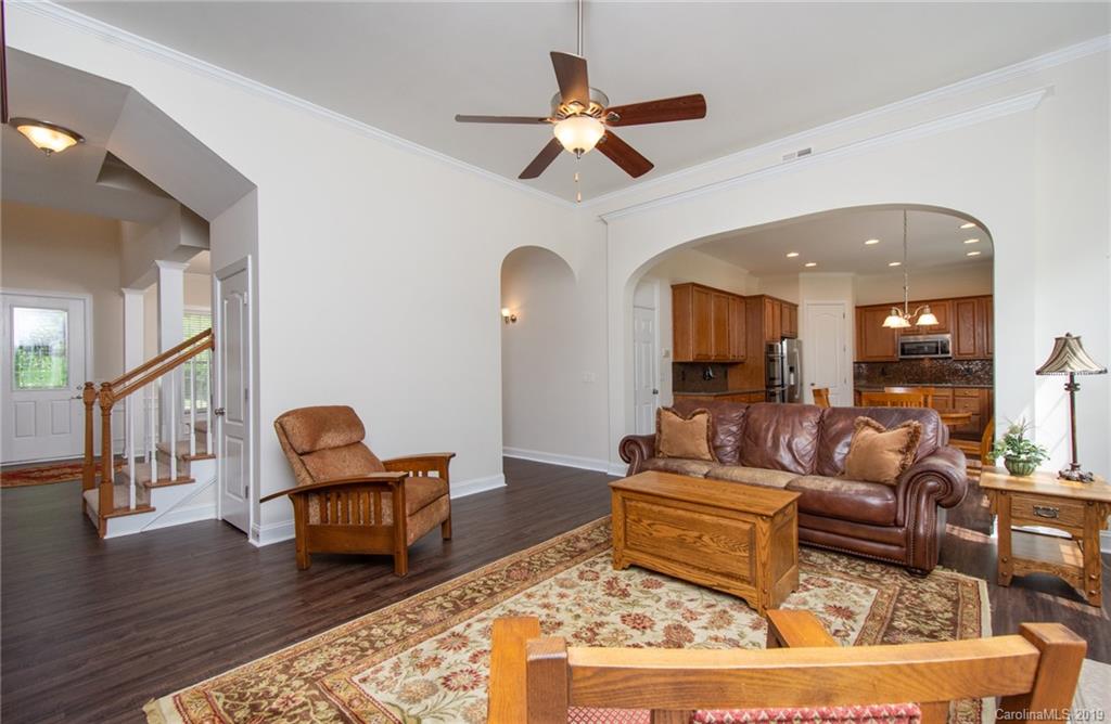 538 Quicksilver Trail Fort Mill, SC 29708 - Photo 6 of 39 a living room with couches chairs and a dining table with wooden floor