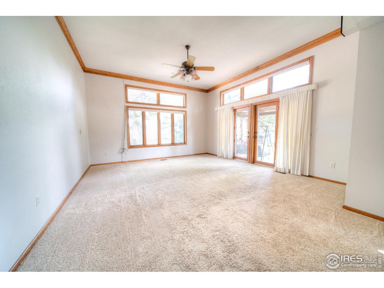 9020 Rogers Road Longmont, CO 80503 - Photo 9 of 39 a view of a livingroom with a ceiling fan and window