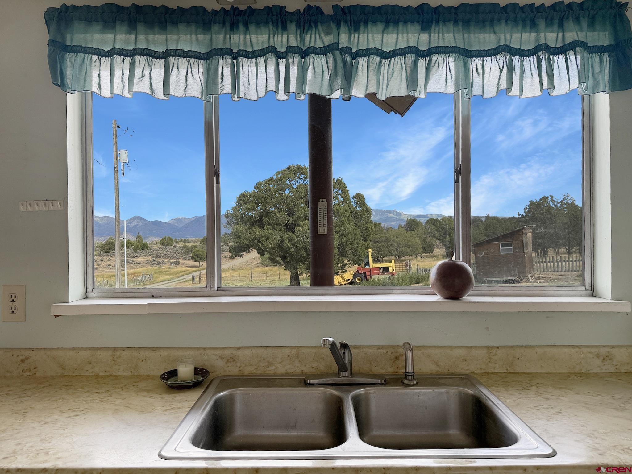 34706 Fruitland Mesa Road Crawford, CO 81415 - Photo 12 of 45 a kitchen with a sink and a window