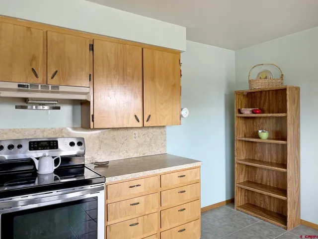 a kitchen with stainless steel appliances a stove a sink and a cabinets