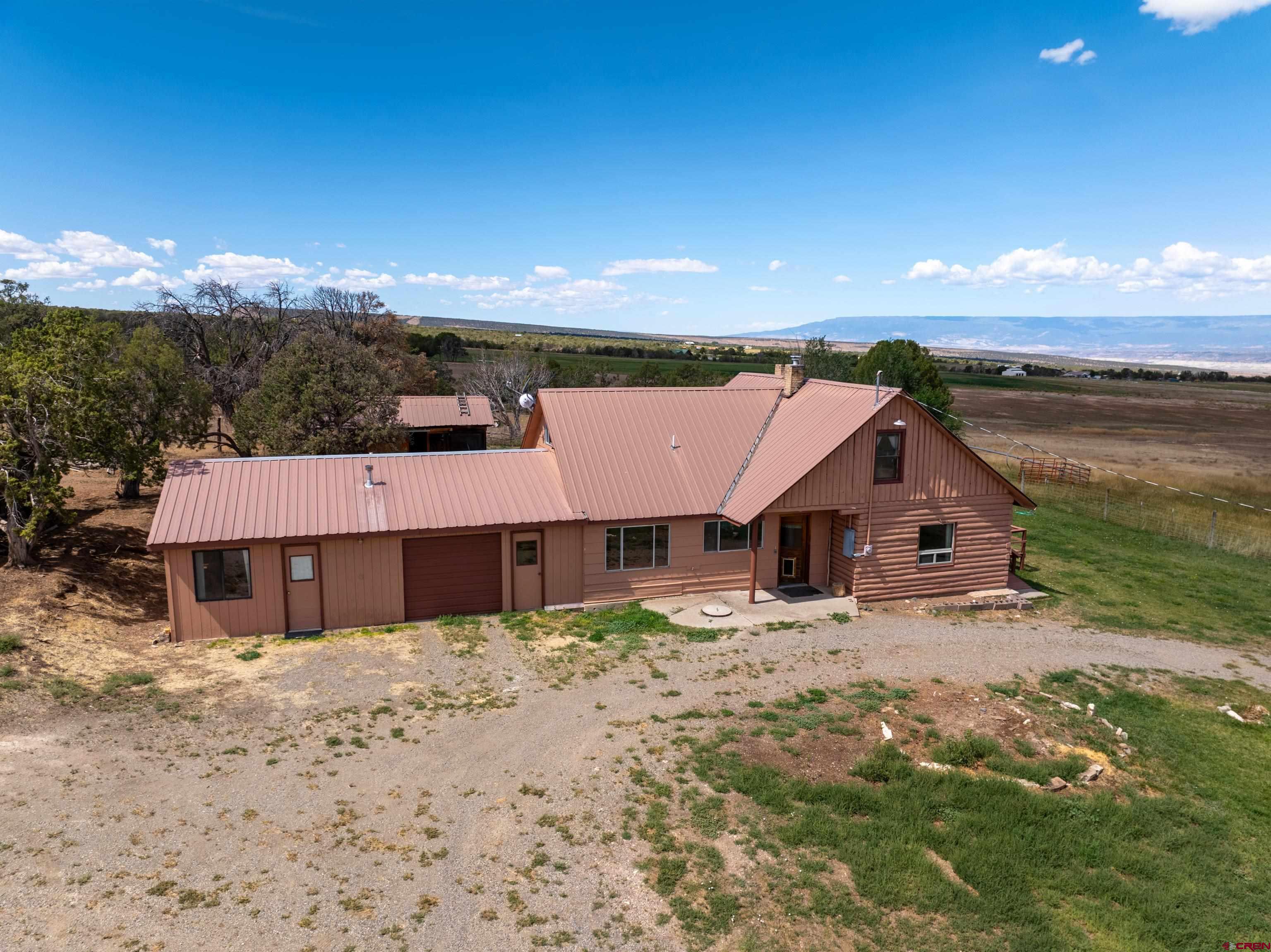 34706 Fruitland Mesa Road Crawford, CO 81415 - Photo 26 of 45 a view of a house with a yard and large tree
