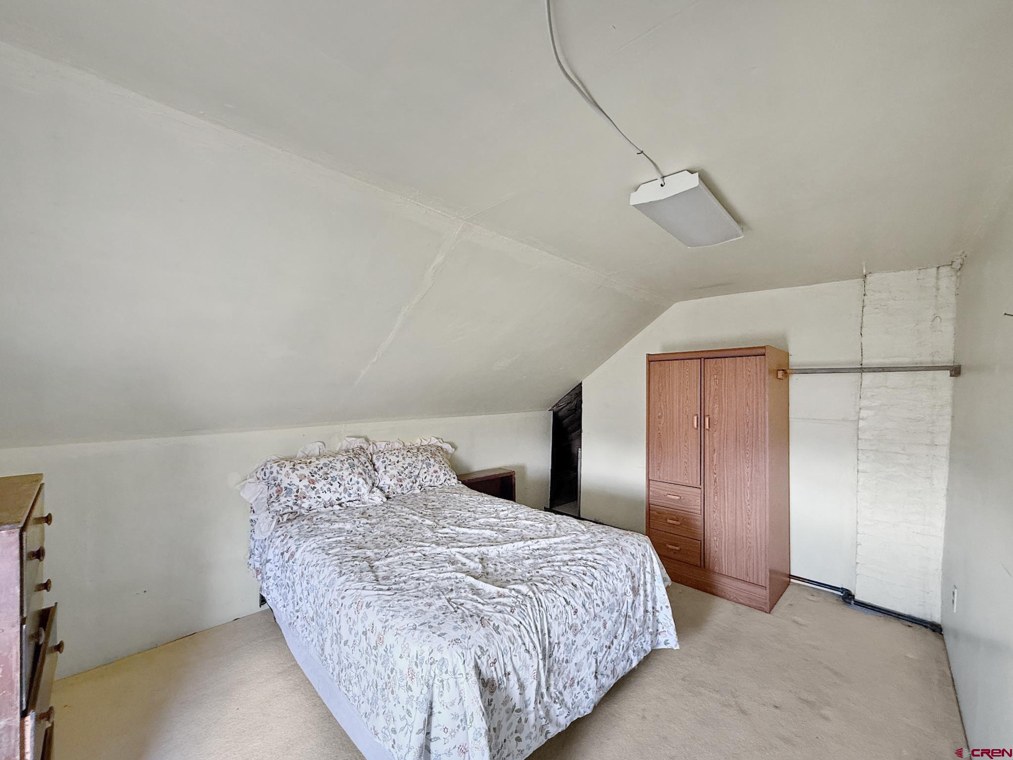 34706 Fruitland Mesa Road Crawford, CO 81415 - Photo 28 of 45 a bedroom with a bed and a night stand