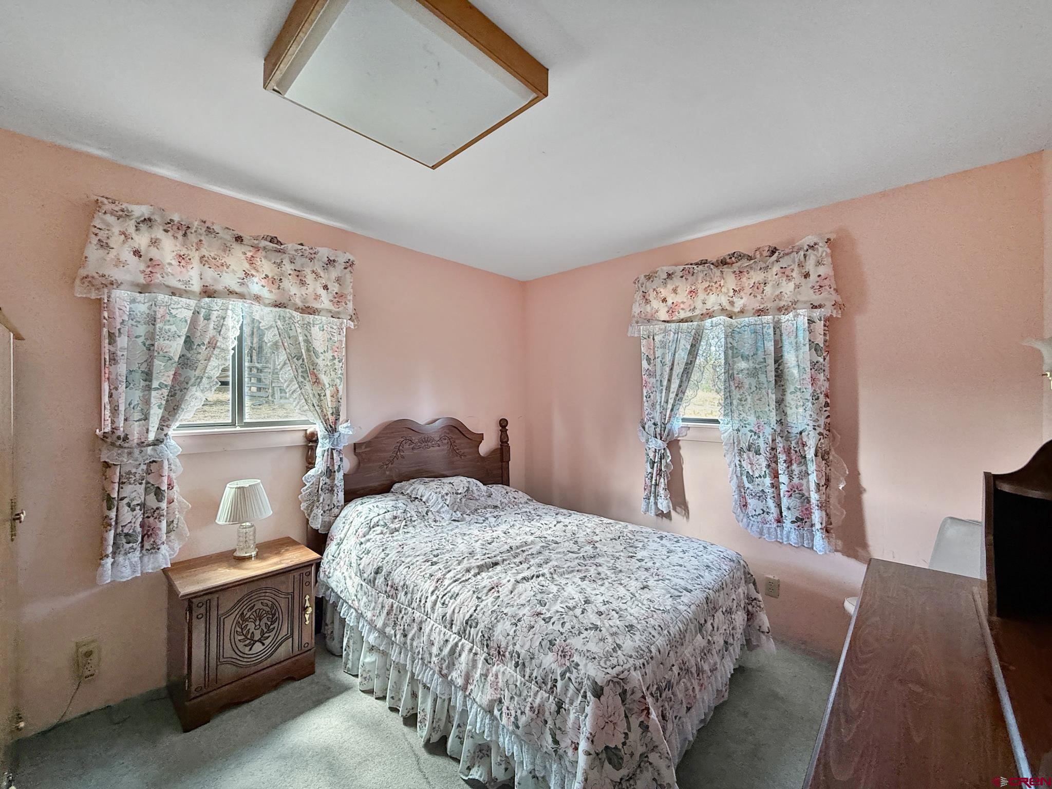 34706 Fruitland Mesa Road Crawford, CO 81415 - Photo 31 of 45 a bedroom with a large bed and a window