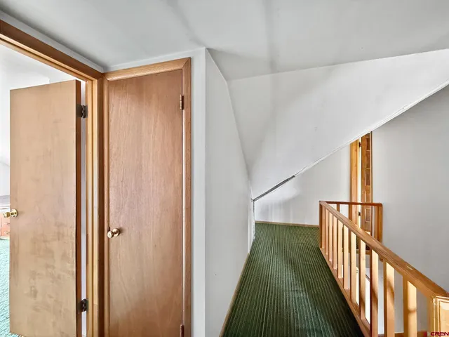 a bedroom with a bed and a desk