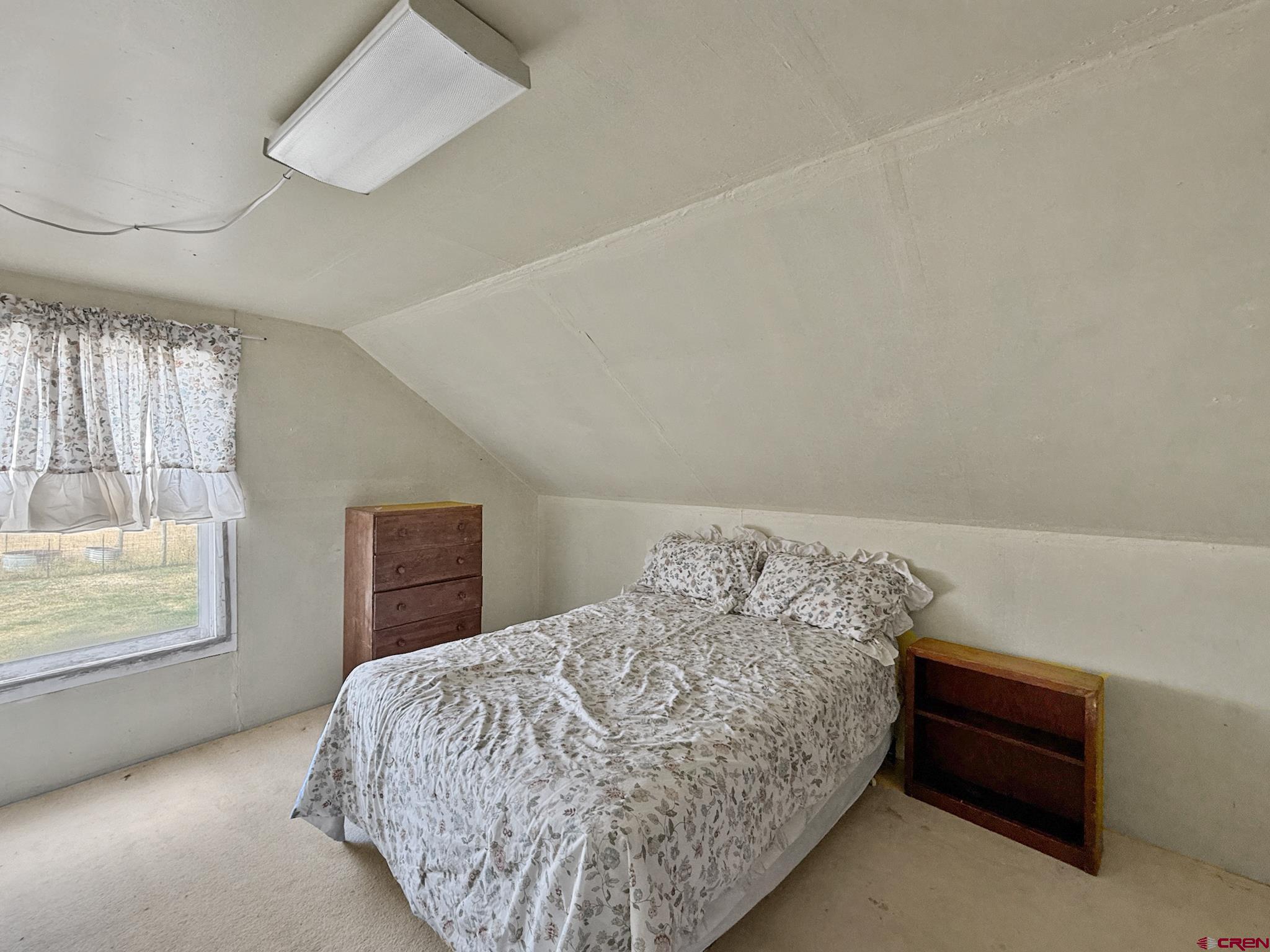 34706 Fruitland Mesa Road Crawford, CO 81415 - Photo 38 of 45 a bedroom with a bed and window