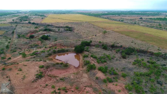 a view of a lake and green valley