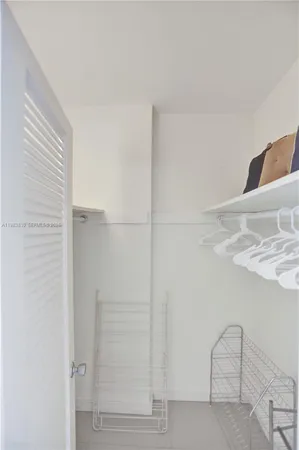 a view of a dining room with furniture and a chandelier