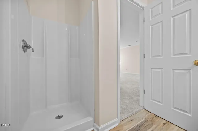 a bathroom with a glass shower door