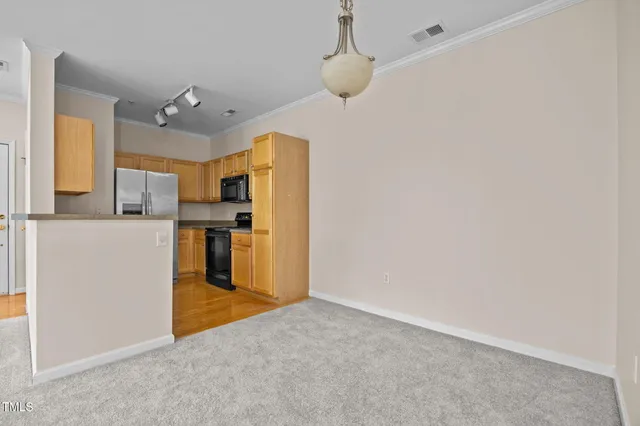 a view of a kitchen with a refrigerator a microwave and a sink