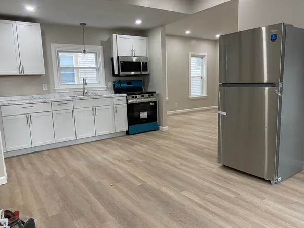 a kitchen with stainless steel appliances a refrigerator sink and microwave