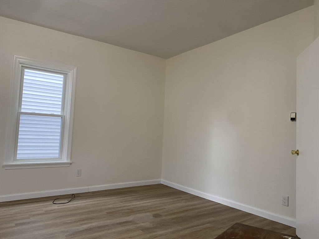 74 Upham Street, Unit 1 Malden, MA 02148 - Photo 7 of 10 wooden floor in an empty room