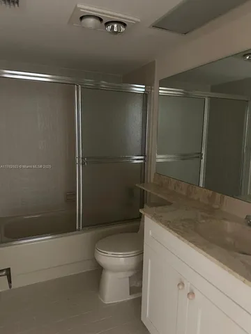 a bathroom with a shower and a sink