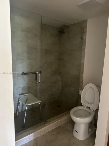 a view of a livingroom with an empty space and a window