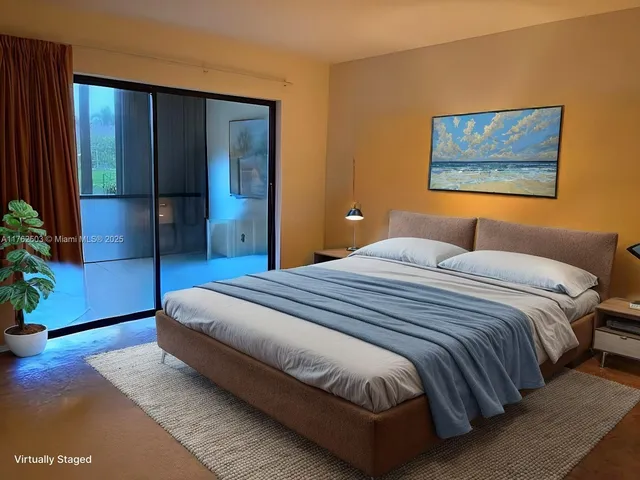 a bedroom with a bed and a painting on the wall