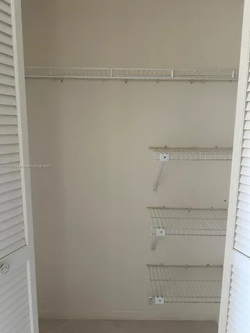 a view of a kitchen with a sink wooden floor and a chandelier