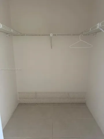 a kitchen with stainless steel appliances granite countertop a refrigerator a stove and a sink with wooden cabinets