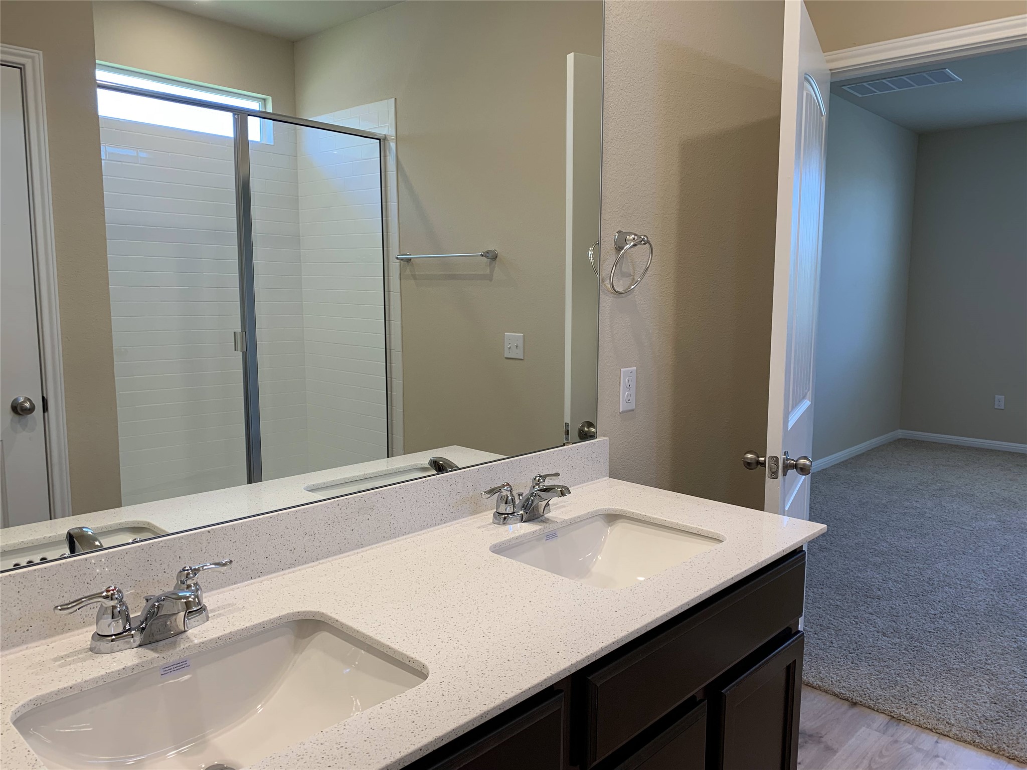 100 Royal Palm Way Leander, TX 78641 - Photo 13 of 29 Full bath with a shower with door, visible vents, double vanity, and a sink