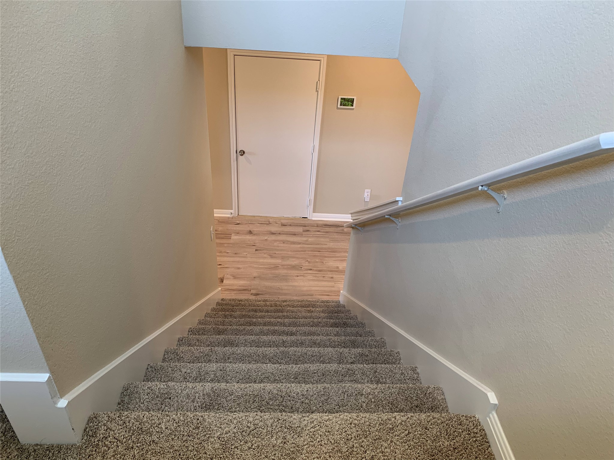 100 Royal Palm Way Leander, TX 78641 - Photo 18 of 29 Staircase with baseboards, a textured wall, and wood finished floors