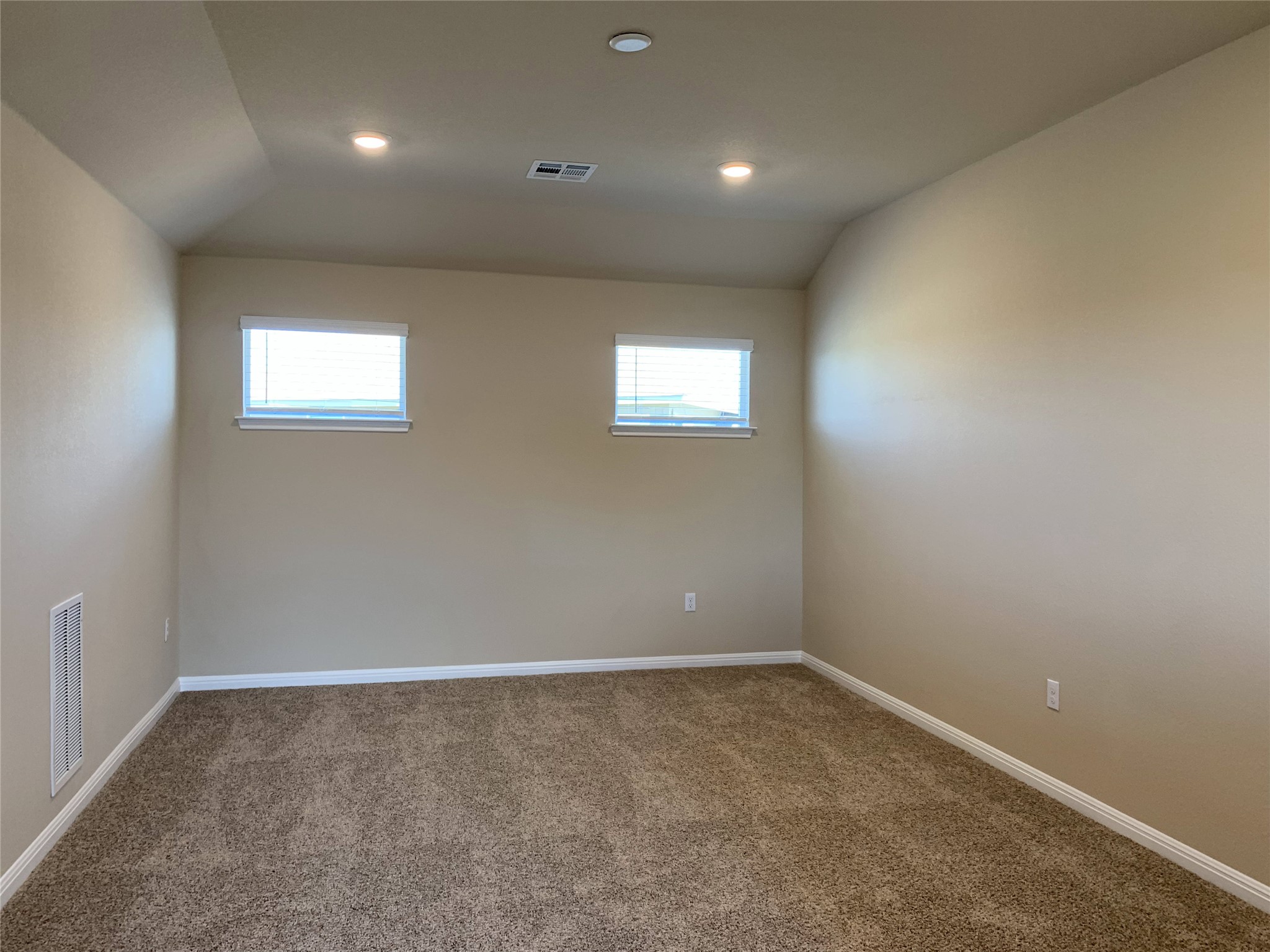 100 Royal Palm Way Leander, TX 78641 - Photo 19 of 29 Carpeted spare room with baseboards, a healthy amount of sunlight, lofted ceiling, and visible vents