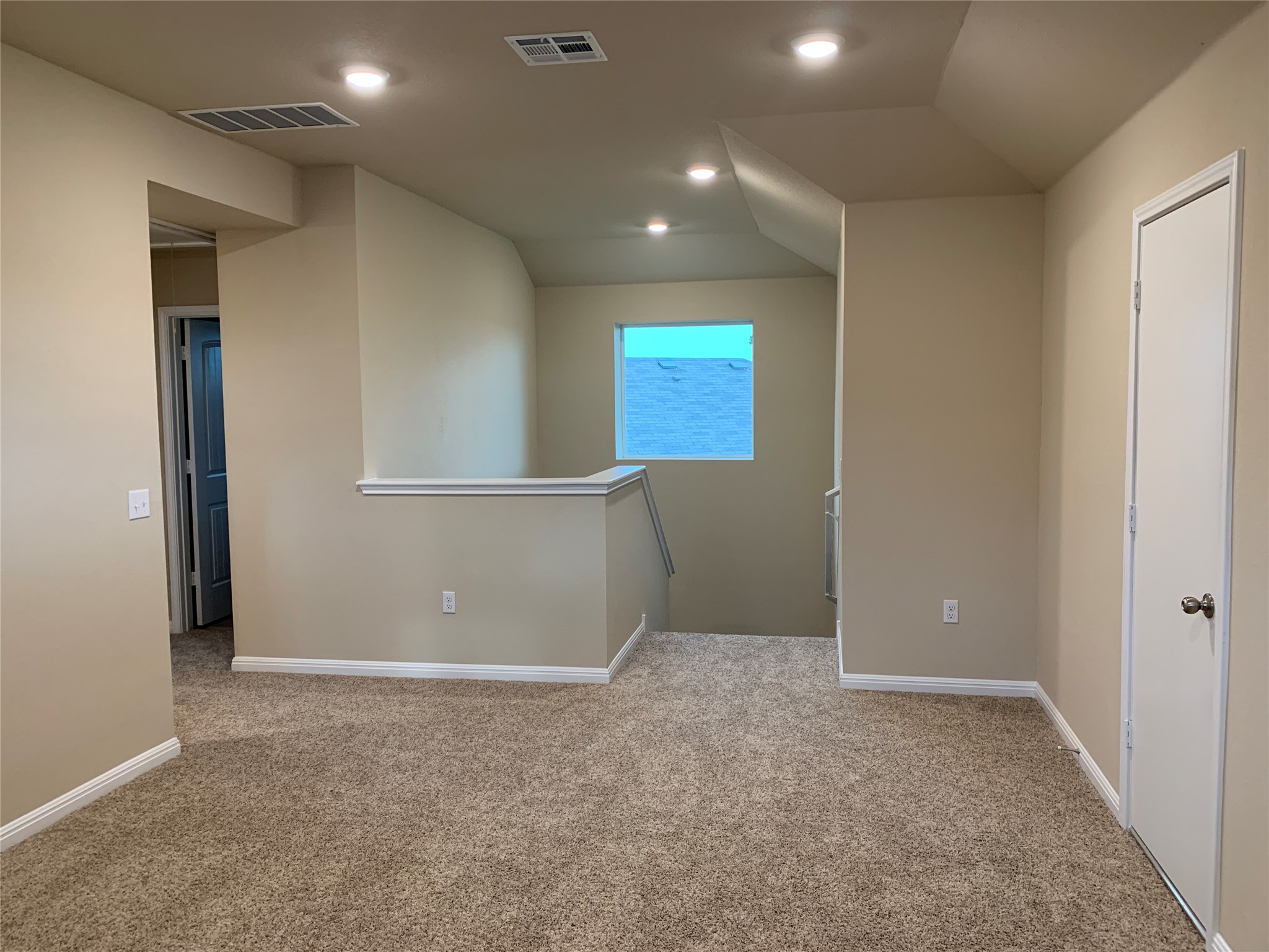 100 Royal Palm Way Leander, TX 78641 - Photo 23 of 29 Carpeted spare room featuring baseboards, visible vents, lofted ceiling, and recessed lighting