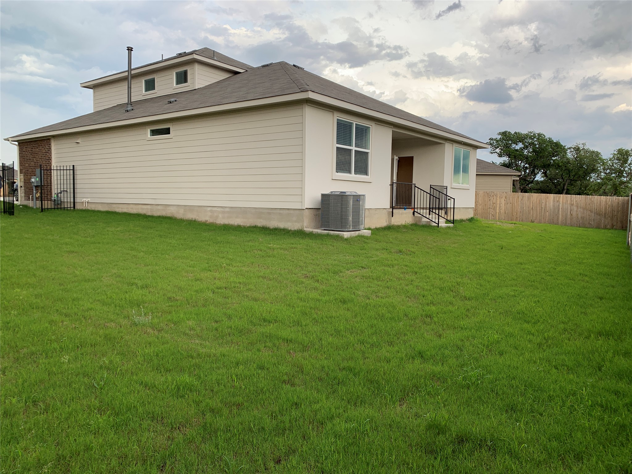 100 Royal Palm Way Leander, TX 78641 - Photo 27 of 29 Rear view of property with central AC, fence, and a lawn
